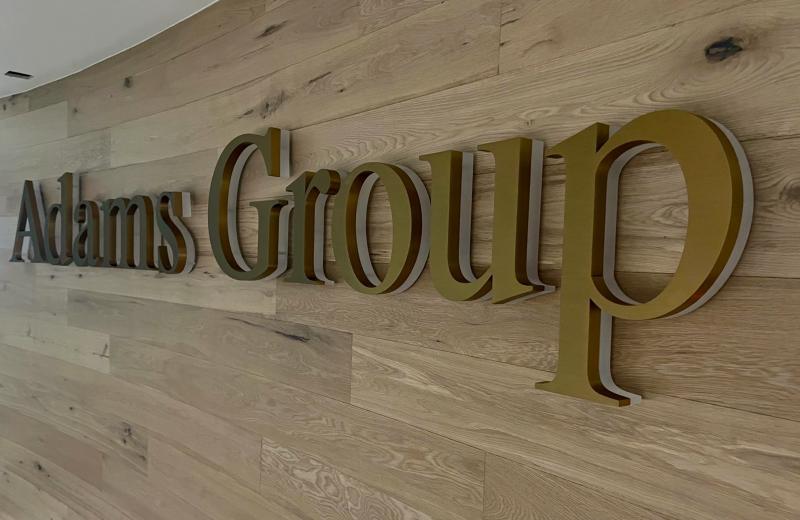Adams Group Brass fabricated logo with frosted acrylic underneath