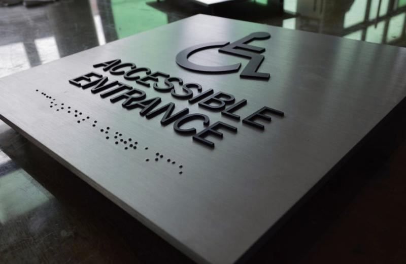 Braille signage in stainless steel with raised text