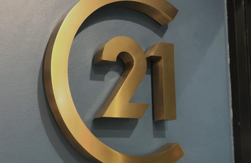 c21-logo-in-a-fabricated-brushed-brass