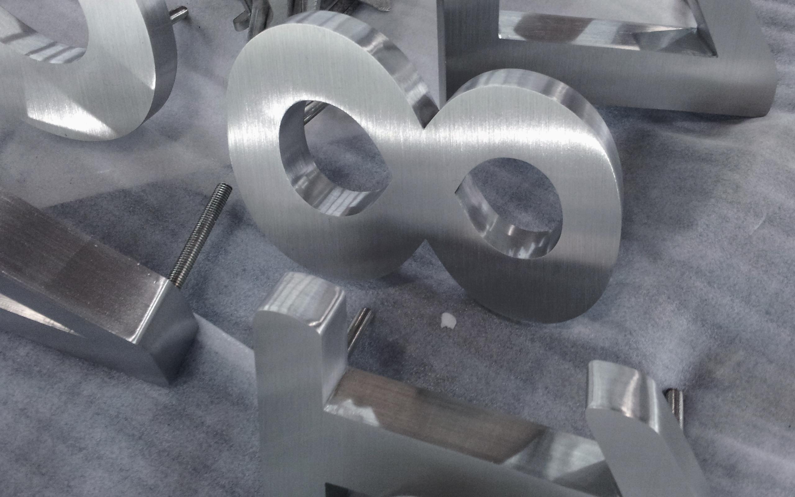 Fabricated brushed stainless steel numbers