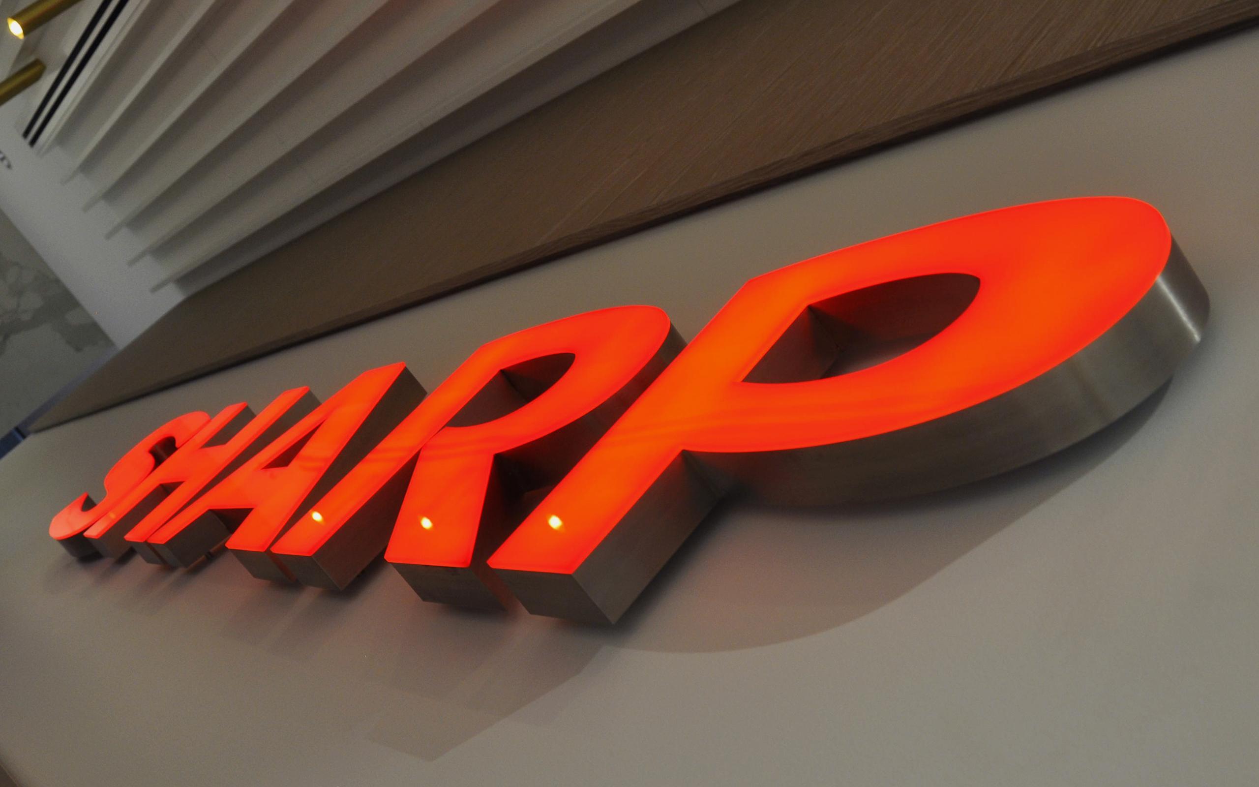sharp logo illuminated indivual letters with raised faces